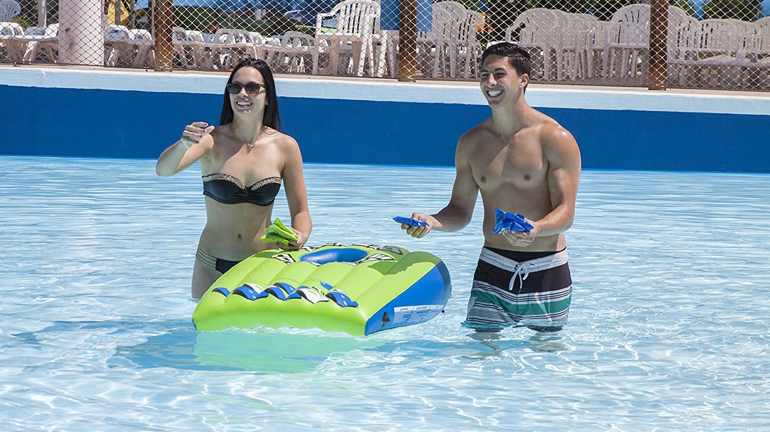 adults playing pool cornhole