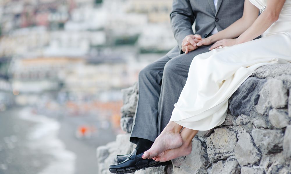 Bride and groom relaxing in wedding day in Positano, Amalfi coast