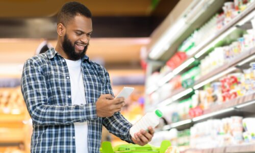 Man scans product at grocery store with phone