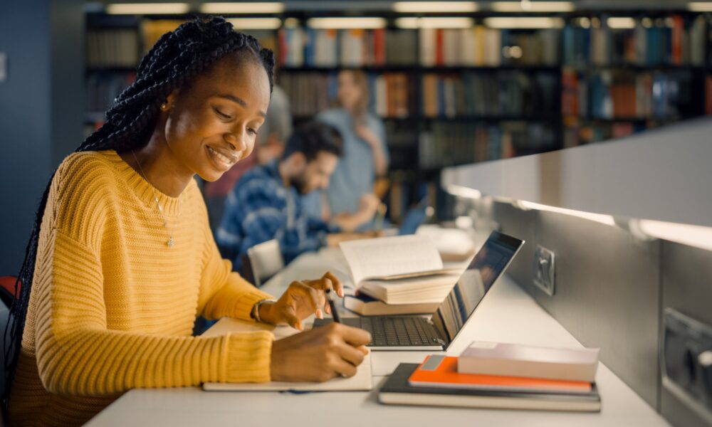 College student studies in library