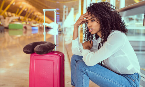 Irritated woman sitting at airport