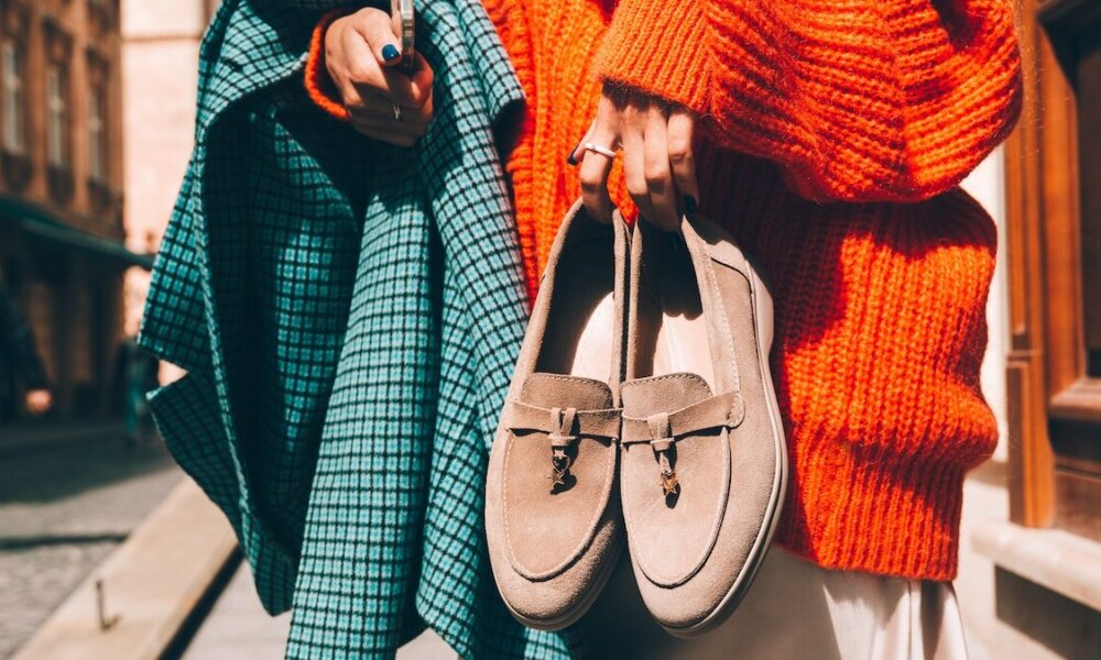 woman holding suede shoes