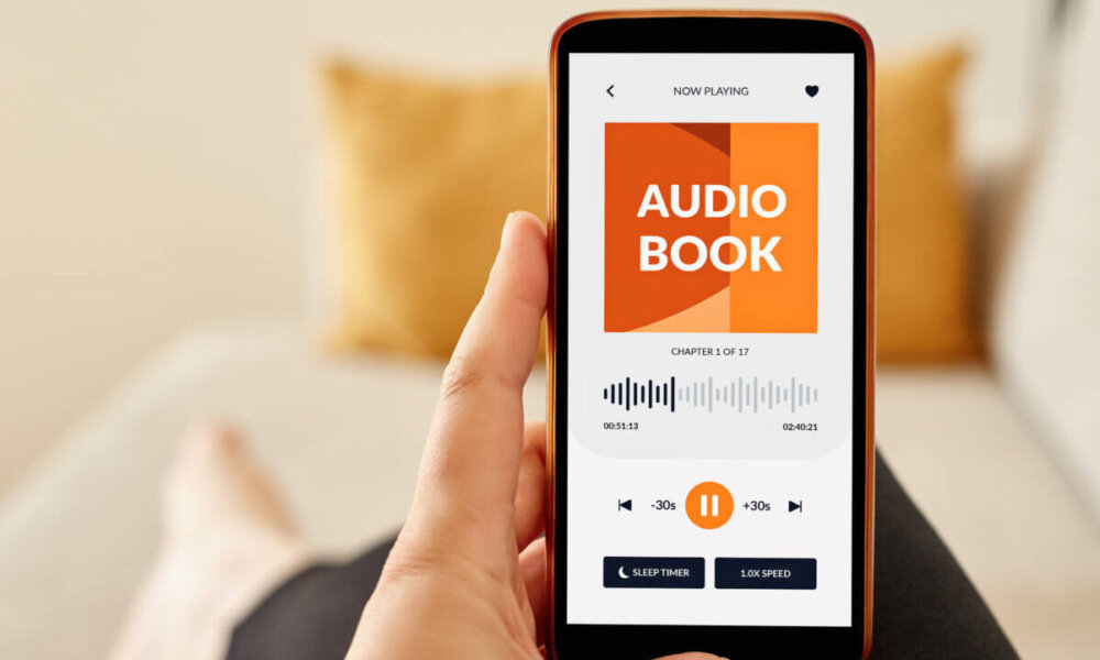 A person listens to an audiobook on their phone.