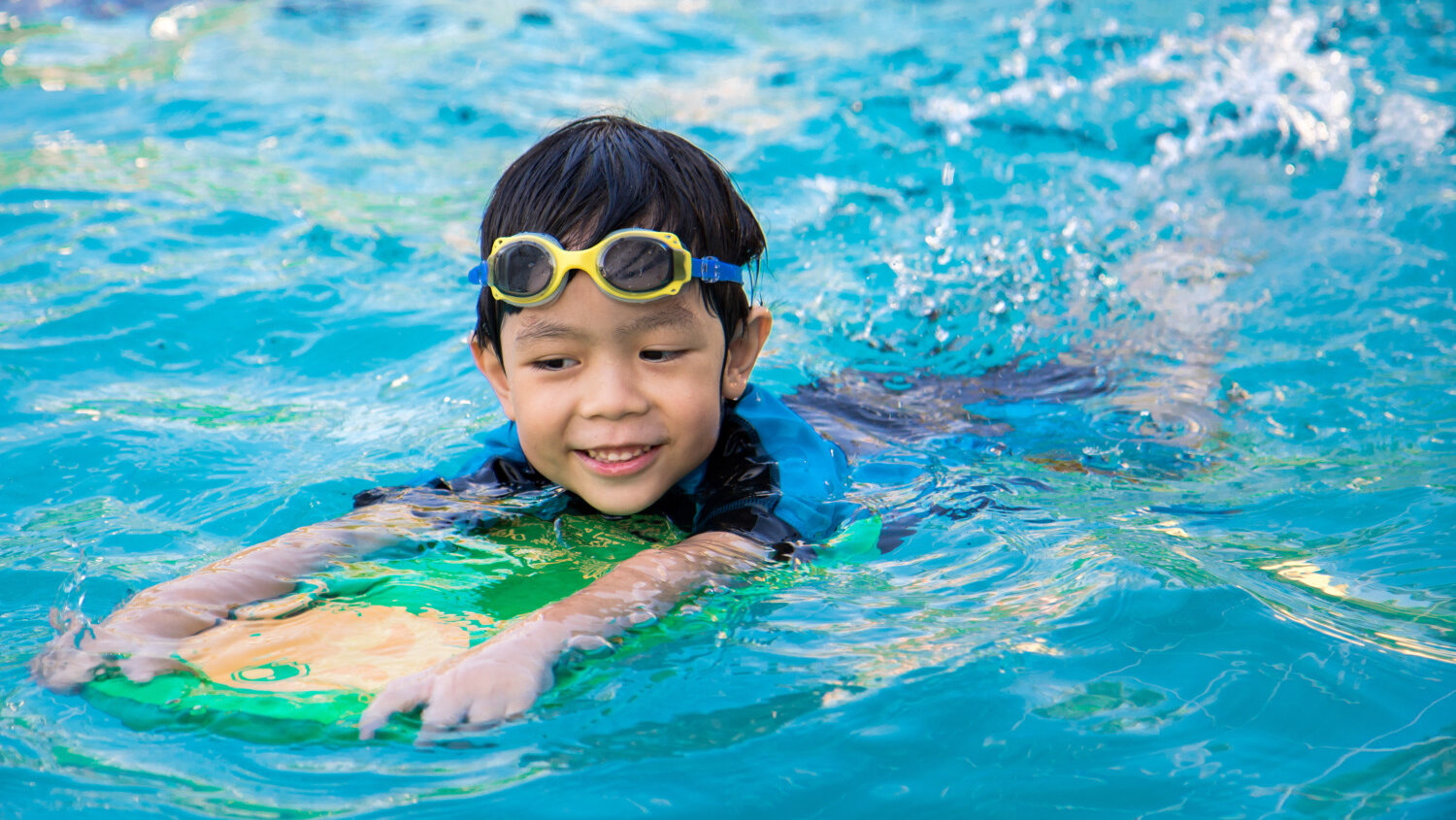 boy swimming in pool