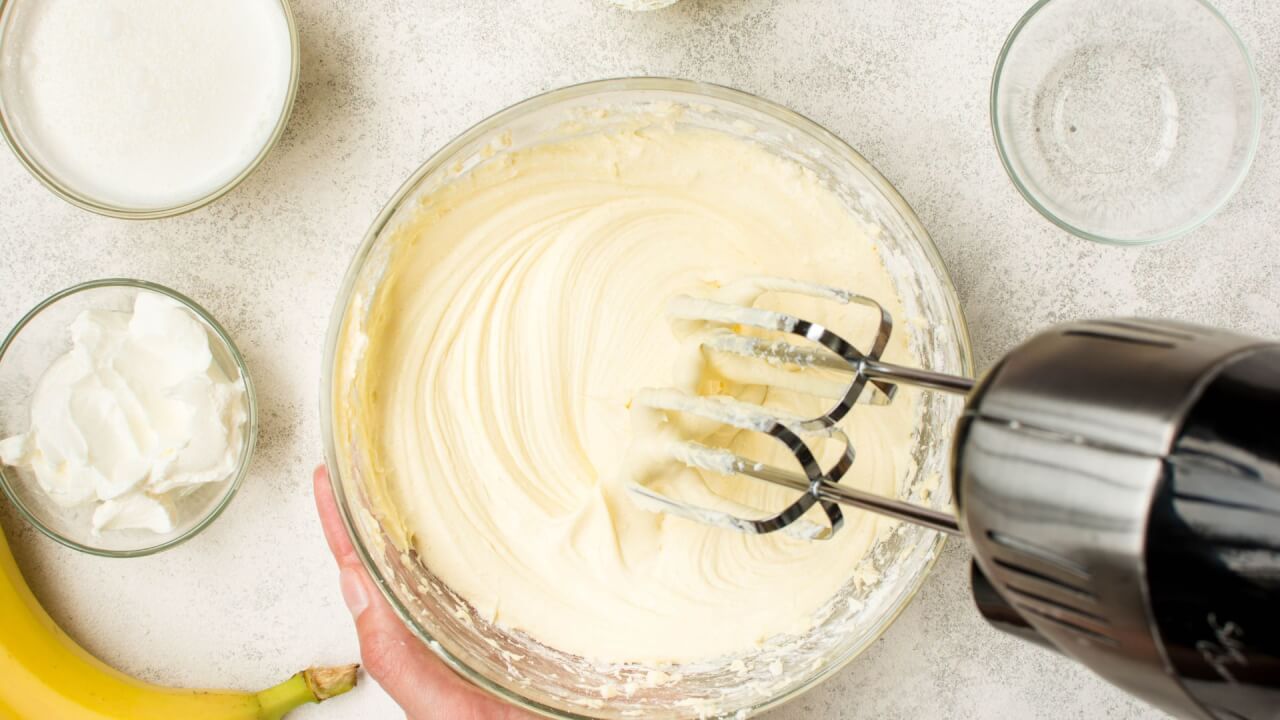 person using a mixer to make heavy cream