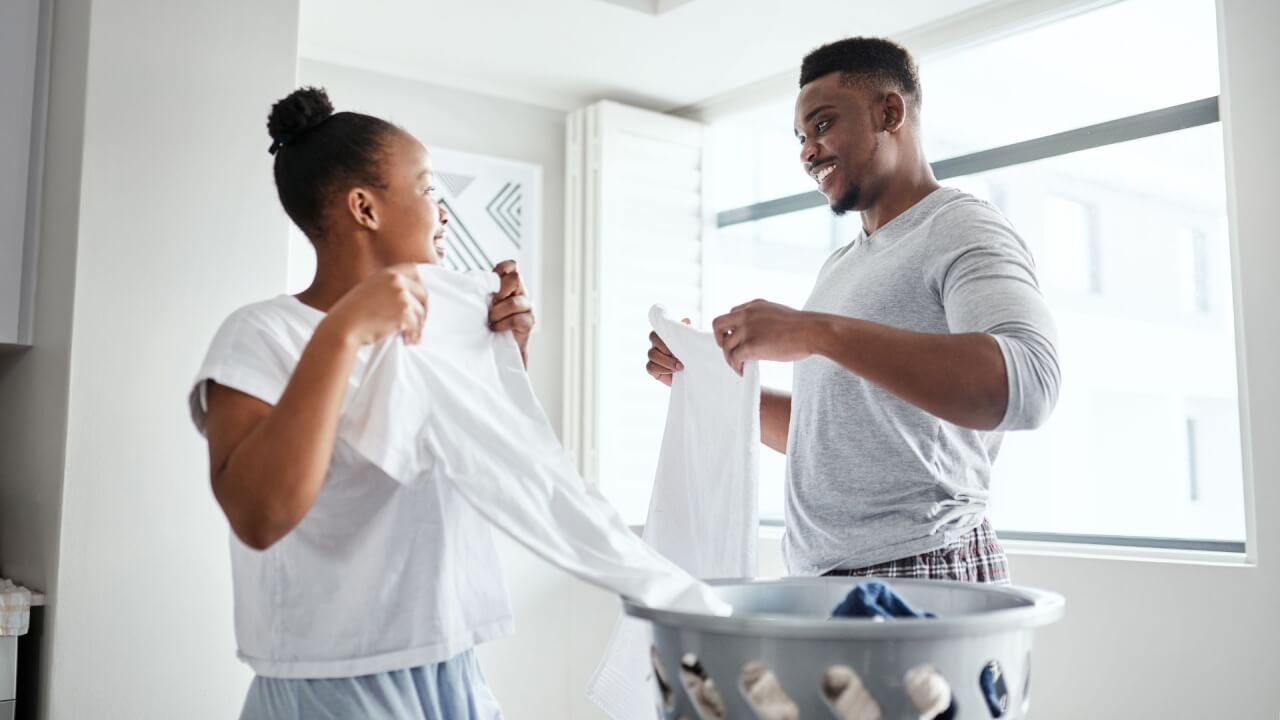 two people folding towels